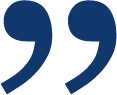 Two bold, dark blue closing quotation marks on gray, representing trusted dog training services—smooth, thick, slightly tilted.
